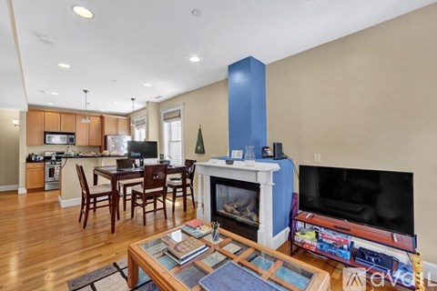 A living room with a fireplace and a television.