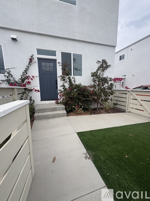 A white house with a blue door and window.