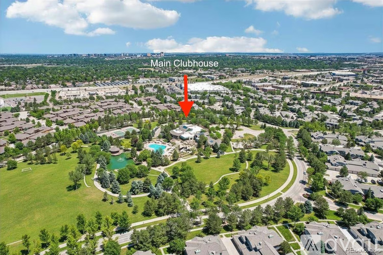 An aerial view of a residential area with a Main Clubhouse indicated by a red arrow.
