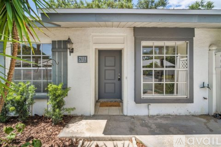 A house with a grey door and a window with a white frame.