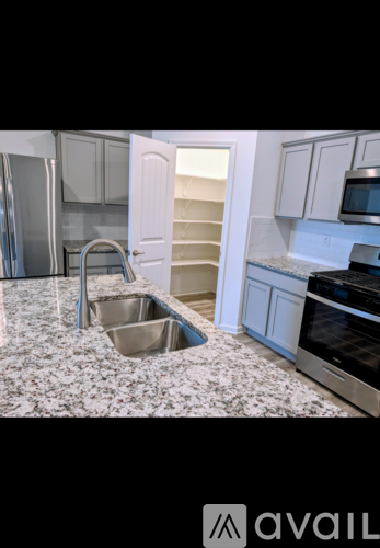 A kitchen with a sink and a refrigerator.
