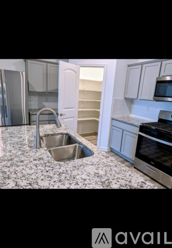 A kitchen with a sink and a refrigerator.