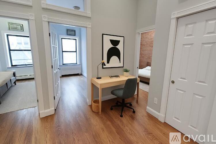 A room with a desk and a chair in it.
