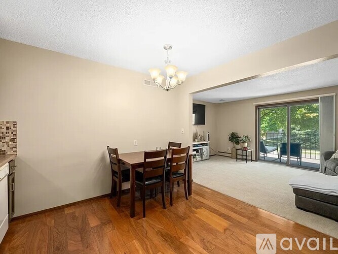 A dining room with a wooden table and chairs.