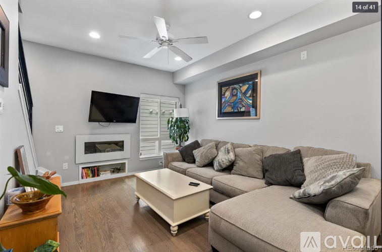 A living room with a grey couch and a television.