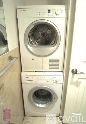 A stack of two front loading washing machines.