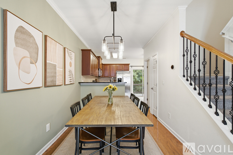 A dining room with a wooden table and chairs.