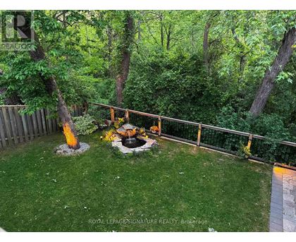 A backyard with a fire pit and a fence.