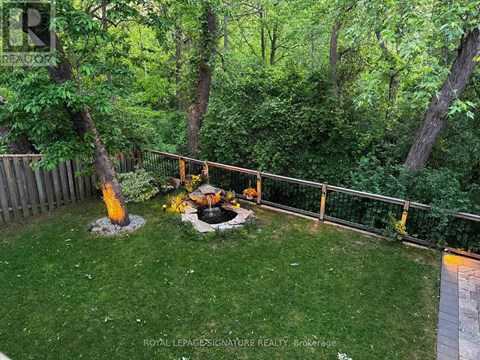 A backyard with a fire pit and a fence.
