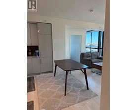 A modern dining room with a table and chairs.