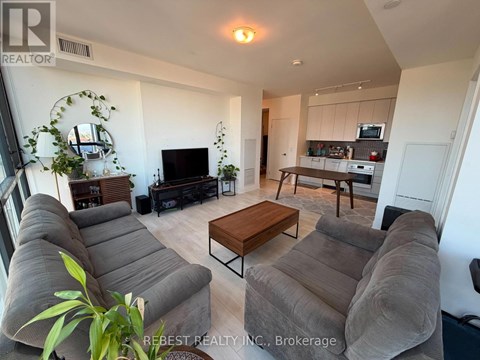 A living room with a grey couch and a wooden coffee table.