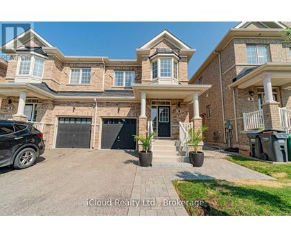 A large, multi-level house with a driveway and a car parked in front.