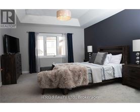 A bedroom with a large bed and a flat screen TV.