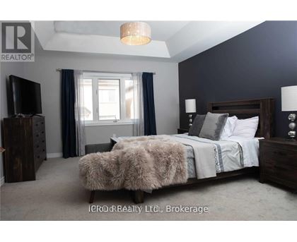 A bedroom with a large bed and a flat screen TV.