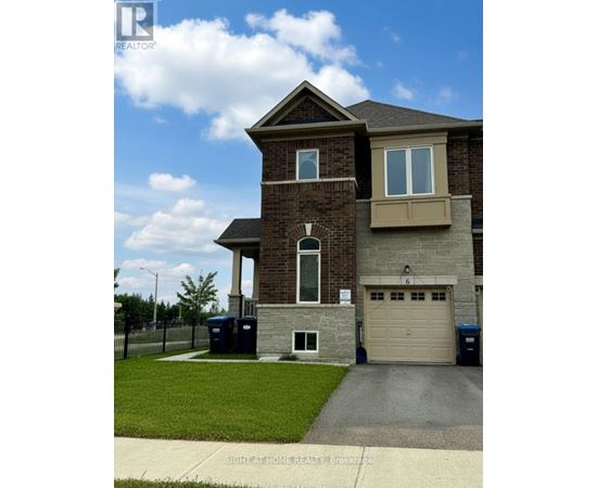 A two-story house with a garage and a driveway in front.