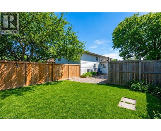 A backyard with a wooden fence and a small garden area.