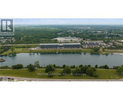 A brokerage company logo is on an aerial shot of a lakefront property.