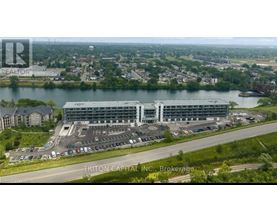 A large building complex with a parking lot in front, situated in a suburban area.