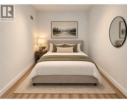 A bedroom with a large bed and a painting on the wall.