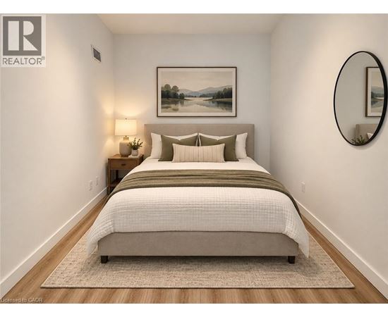 A bedroom with a large bed and a painting on the wall.