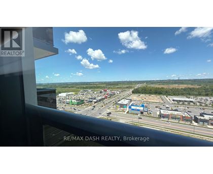 A view from a window of a busy street with a sign that says RE/MAX DASH REALTY, Brokerage.