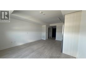 A room with a white wall and a wooden floor.