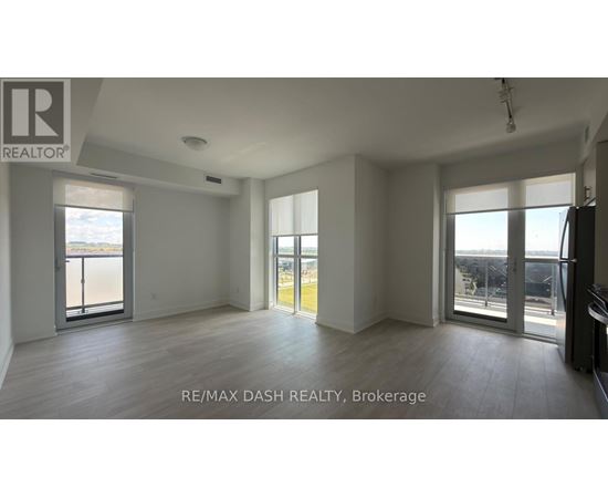 A spacious room with a view of the city through large windows.