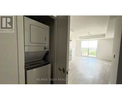 A white refrigerator is in a kitchen with a door open.