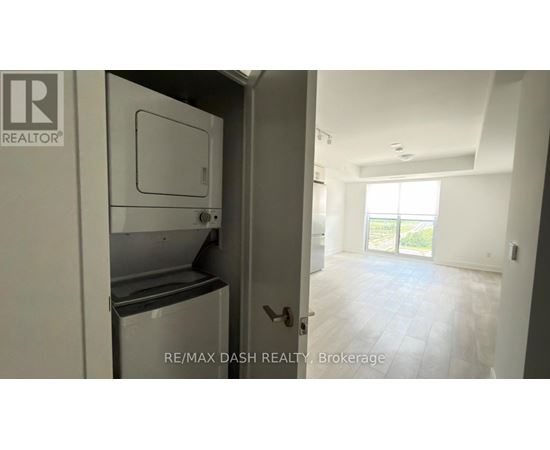 A white refrigerator is in a kitchen with a door open.