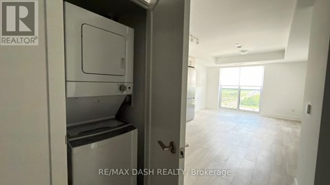 A white refrigerator is in a kitchen with a door open.