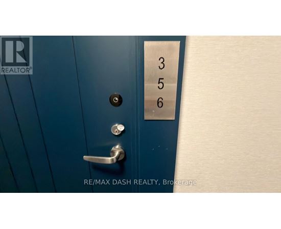 A blue door with a silver handle and a numbered panel on the right.