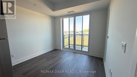 A room with a view of the outside through a large window.