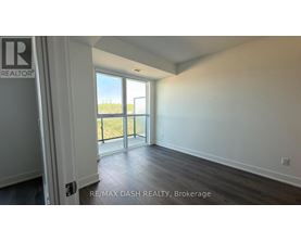 A room with a sliding glass door leading to a balcony.