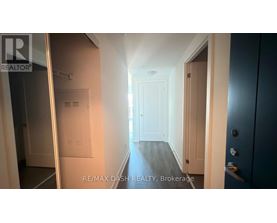 A hallway with a door on the right and a window on the left.