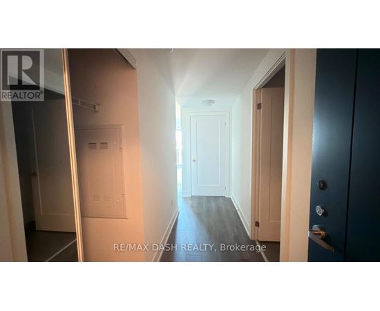 A hallway with a door on the right and a window on the left.