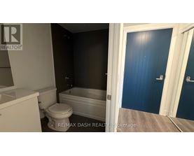 A bathroom with a toilet, sink, and bathtub.