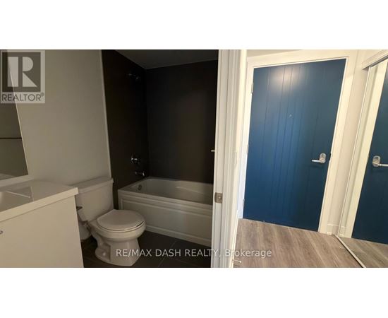 A bathroom with a toilet, sink, and bathtub.