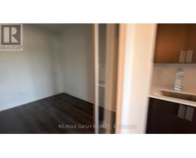 A room with a white wall and a wooden floor.