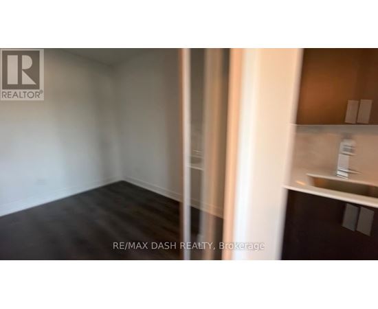 A room with a white wall and a wooden floor.