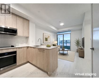 A modern kitchen with wooden cabinets and stainless steel appliances.