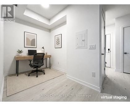 A white room with a desk and a chair.