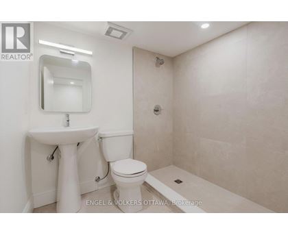 A white sink and toilet in a small bathroom.