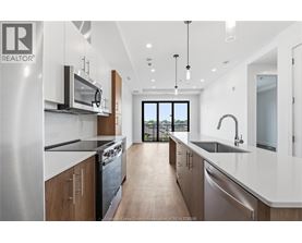 A modern kitchen with a view of the backyard.
