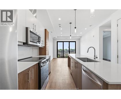 A modern kitchen with a view of the backyard.