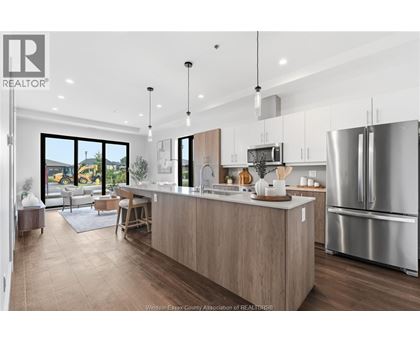 A modern kitchen with wooden cabinets and stainless steel appliances.