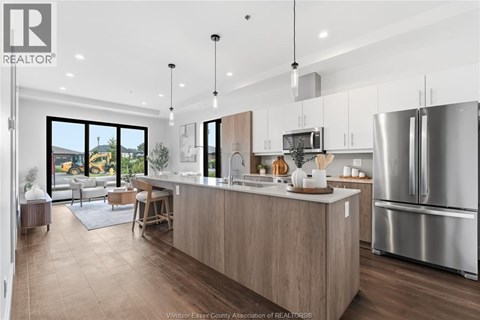 A modern kitchen with wooden cabinets and stainless steel appliances.