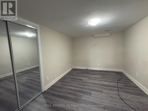A room with a grey floor and a glass door.