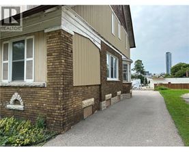 A residential building with a gravel pathway leading to the front door.