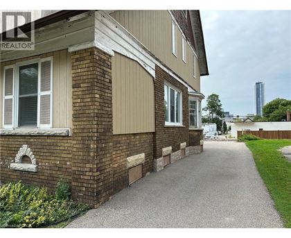 A residential building with a gravel pathway leading to the front door.