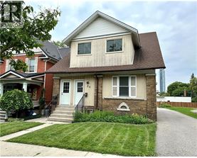 A two-story house with a front porch and a garage door.
